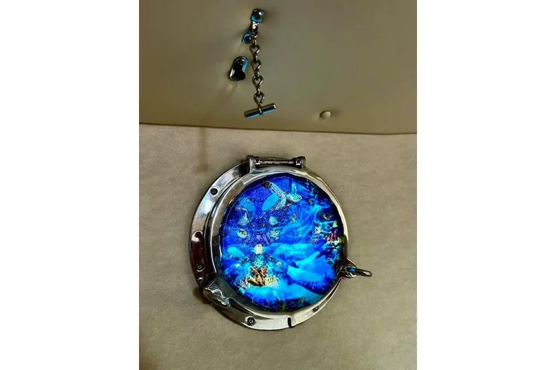 Slide: The Image of Porthole with vibrant blue ocean scene on a 2006 Nordic Tug 37 boat. - 30