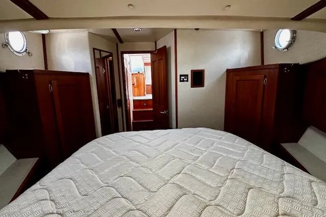 Slide: The Image of Interior cabin of a 2006 Nordic Tug 37 with a bed and wooden cabinetry. - 32