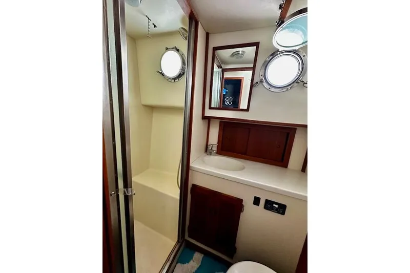 Slide: The Image of Bathroom interior of a 2006 Nordic Tug 37 with shower and porthole window. - 34