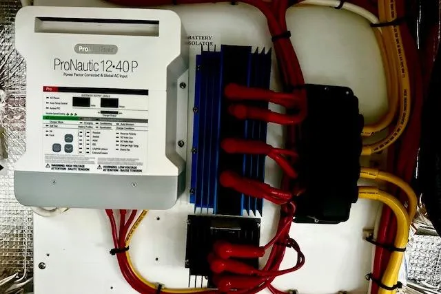Slide: The Image of Electrical panel with ProNautic 12:40P charger on 2006 Nordic Tug 37 boat. - 38