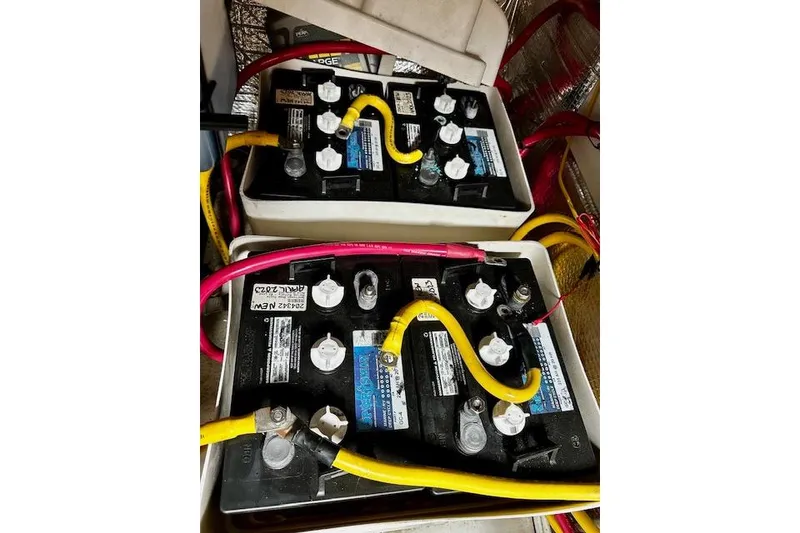 Slide: The Image of Batteries in a 2006 Nordic Tug 37 boat, connected with yellow and red cables. - 39