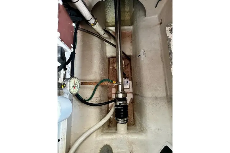 Slide: The Image of Engine compartment of a 2006 Nordic Tug 37, featuring mechanical components and a gauge. - 41