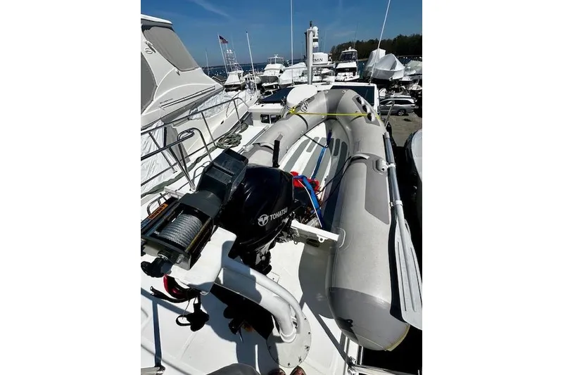 Slide: The Image of 2006 Nordic Tug 37 with inflatable dinghy and Tohatsu outboard motor on deck. - 8