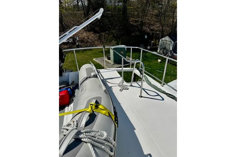 Slide: The Image of Nordic Tug 37 (2006) deck with inflatable boat and railing, outdoor setting. - 9