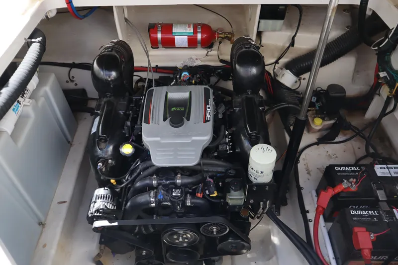Slide: The Image of 2011 Sea Ray Sundancer 280 boat seating area with white upholstery and cup holders. - 25