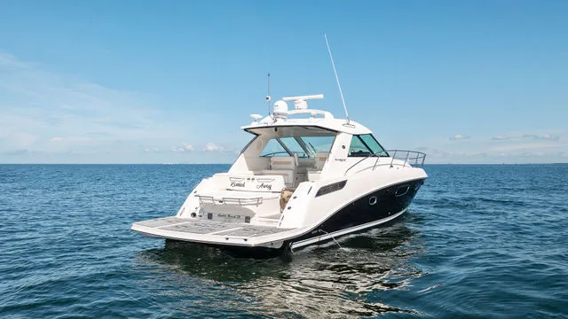 Slide: The Image of 2011 Sea Ray Sundancer 280 boat on trailer, parked near blue building. - 3