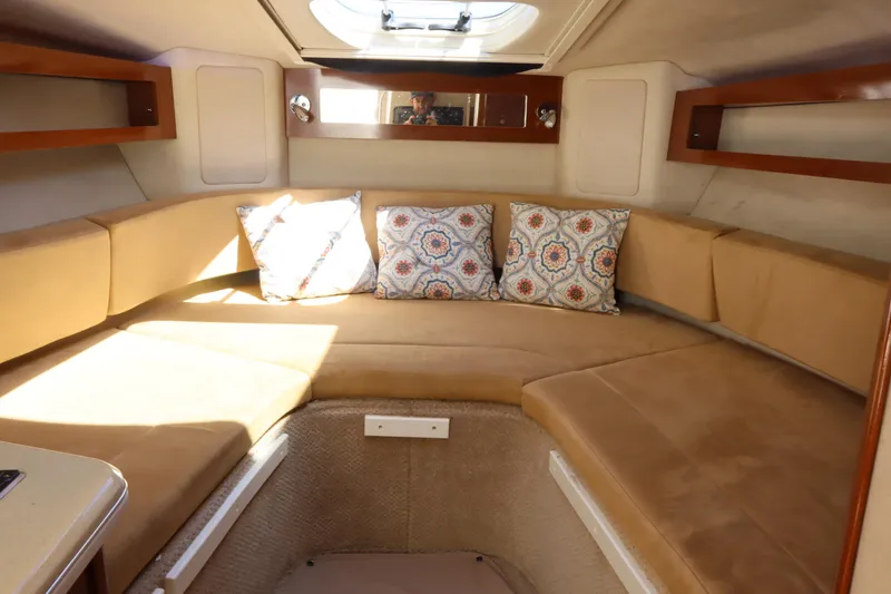 Slide: The Image of Interior of 2011 Sea Ray Sundancer 280 with beige seating and patterned cushions. - 34