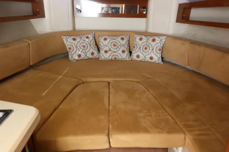 Slide: The Image of Interior of 2011 Sea Ray Sundancer 280 with tan seating and patterned cushions. - 35