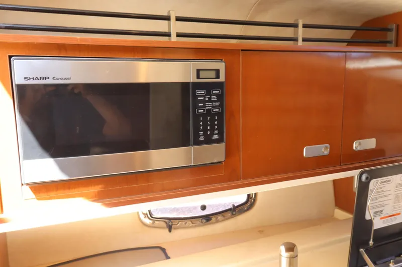 Slide: The Image of Interior of 2011 Sea Ray Sundancer 280 with Sharp Carousel microwave and wooden cabinets. - 37