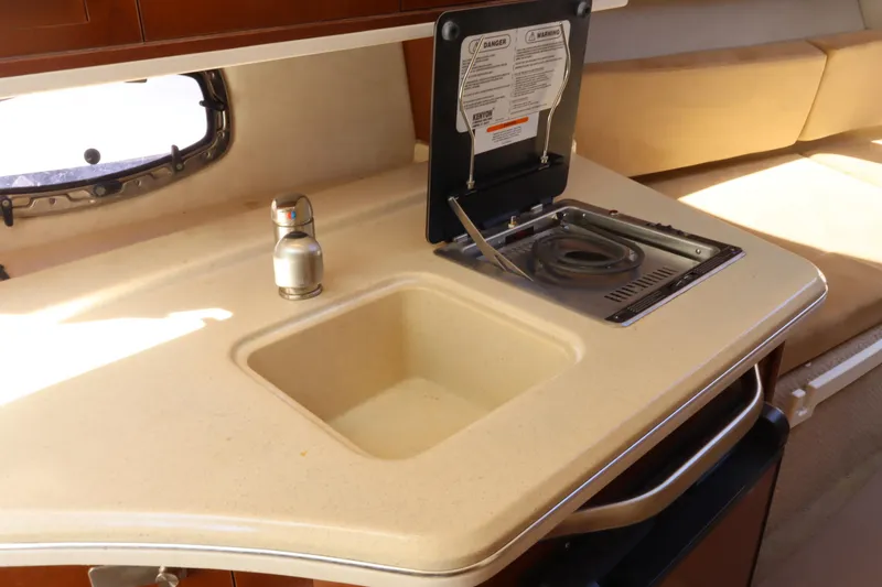 Slide: The Image of Interior of 2011 Sea Ray Sundancer 280 with sink and stove in kitchenette. - 38