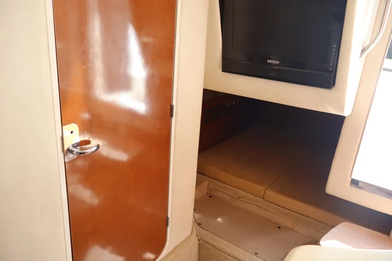 Slide: The Image of Interior of 2011 Sea Ray Sundancer 280 with wooden door and mounted TV. - 44