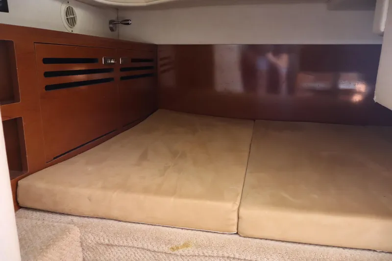 Slide: The Image of Interior cabin of 2011 Sea Ray Sundancer 280 with cushioned sleeping area. - 45
