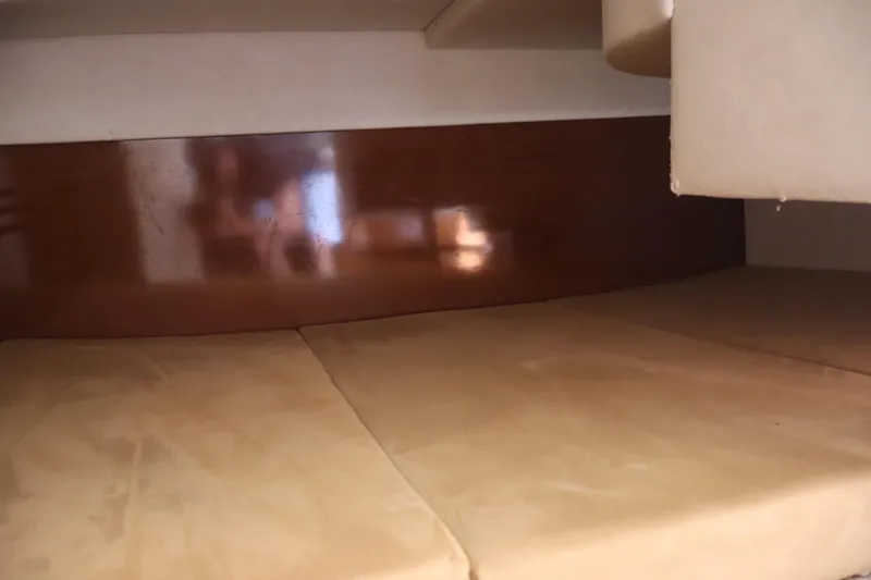 Slide: The Image of Interior cabin view of 2011 Sea Ray Sundancer 280, featuring beige upholstery and wooden paneling. - 46