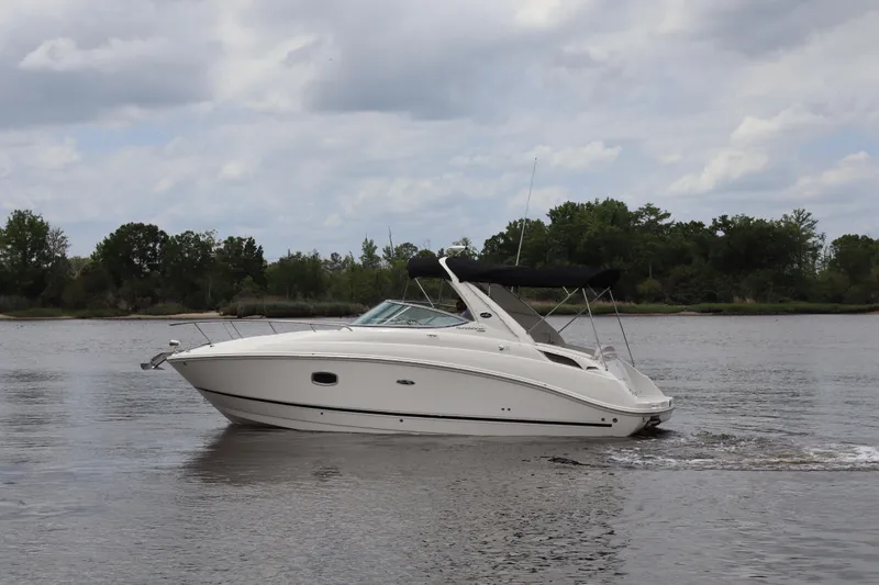 Slide: The Image of 2011 Sea Ray Sundancer 280 cruising on a calm river under a cloudy sky. - 47