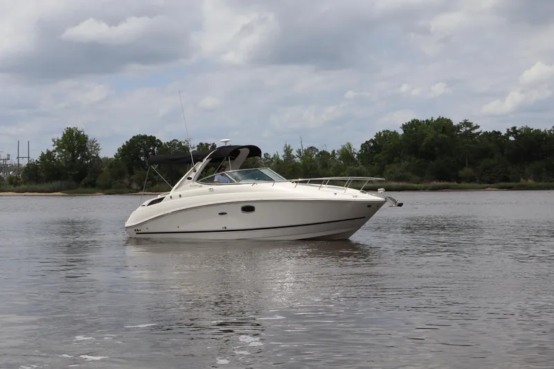 Slide: The Image of 2011 Sea Ray Sundancer 280 boat on calm water under cloudy sky. - 49