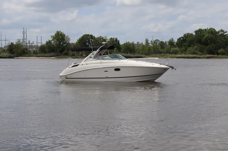 Slide: The Image of 2011 Sea Ray Sundancer 280 cruising on a calm river under a cloudy sky. - 51