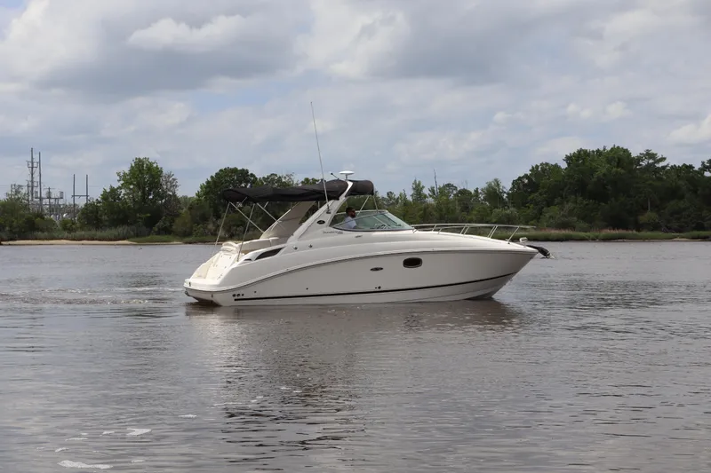 Slide: The Image of 2011 Sea Ray Sundancer 280 cruising on a calm river under a cloudy sky. - 53