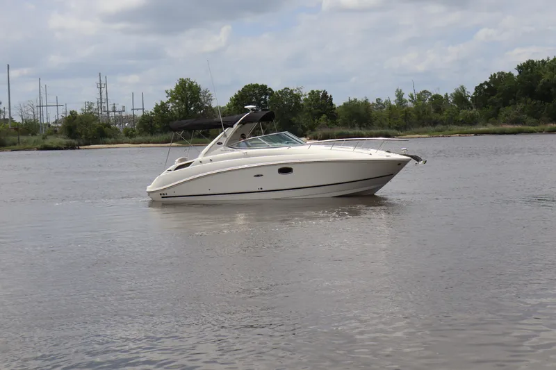 Slide: The Image of 2011 Sea Ray Sundancer 280 cruising on a calm river under a cloudy sky. - 54