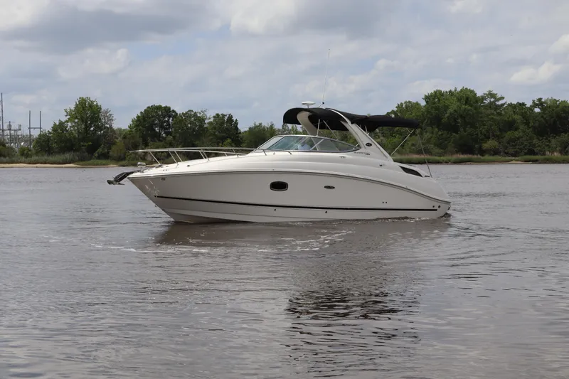 Slide: The Image of 2011 Sea Ray Sundancer 280 cruising on a calm river under a cloudy sky. - 56