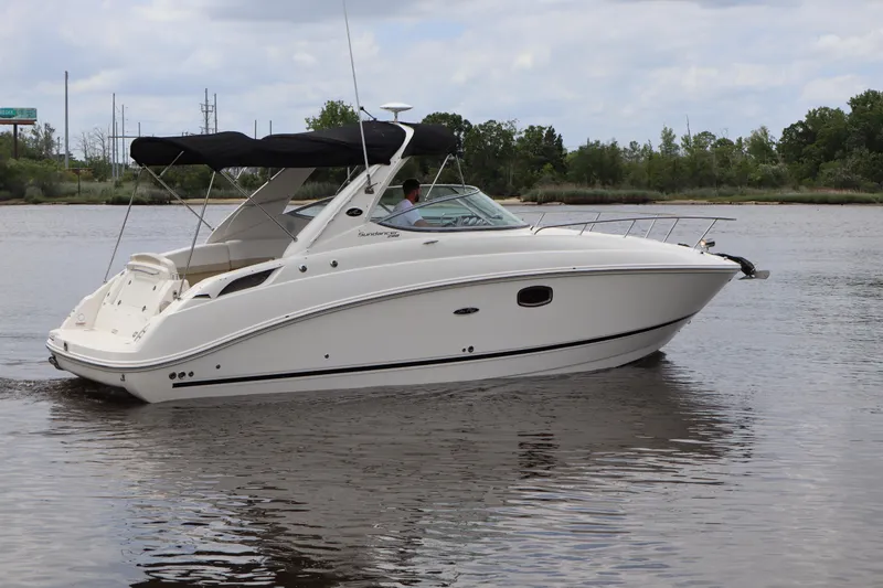 Slide: The Image of 2011 Sea Ray Sundancer 280 cruising on a calm river under a cloudy sky. - 57