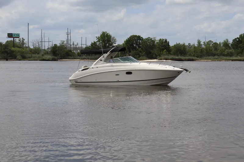 Slide: The Image of 2011 Sea Ray Sundancer 280 boat on calm water under cloudy sky. - 58