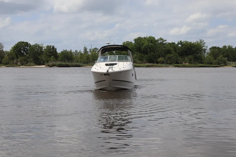 Slide: The Image of 2011 Sea Ray Sundancer 280 cruising on a calm river with lush green shoreline. - 60