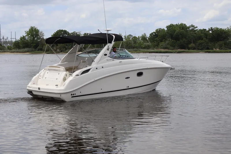 Slide: The Image of 2011 Sea Ray Sundancer 280 cruising on a calm river with lush greenery. - 61