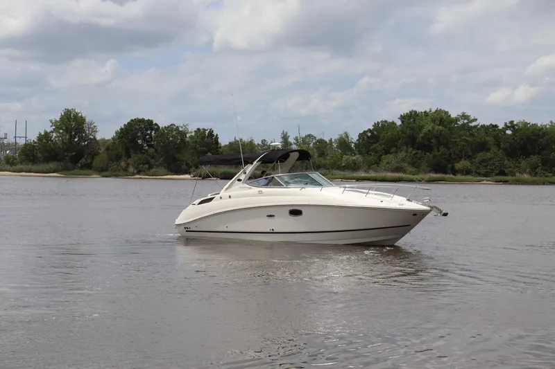 Slide: The Image of 2011 Sea Ray Sundancer 280 cruising on a calm river under a cloudy sky. - 63