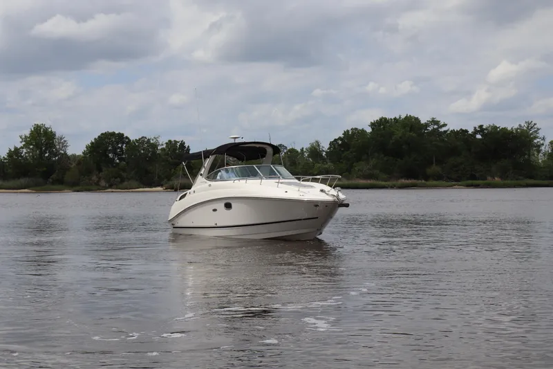 Slide: The Image of 2011 Sea Ray Sundancer 280 cruising on a calm river under a cloudy sky. - 64