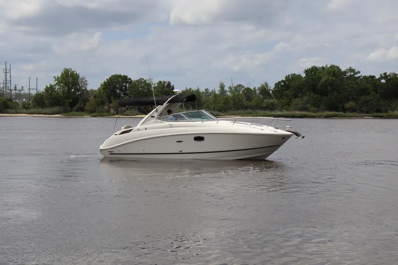 Slide: The Image of 2011 Sea Ray Sundancer 280 cruising on a calm river under a cloudy sky. - 65