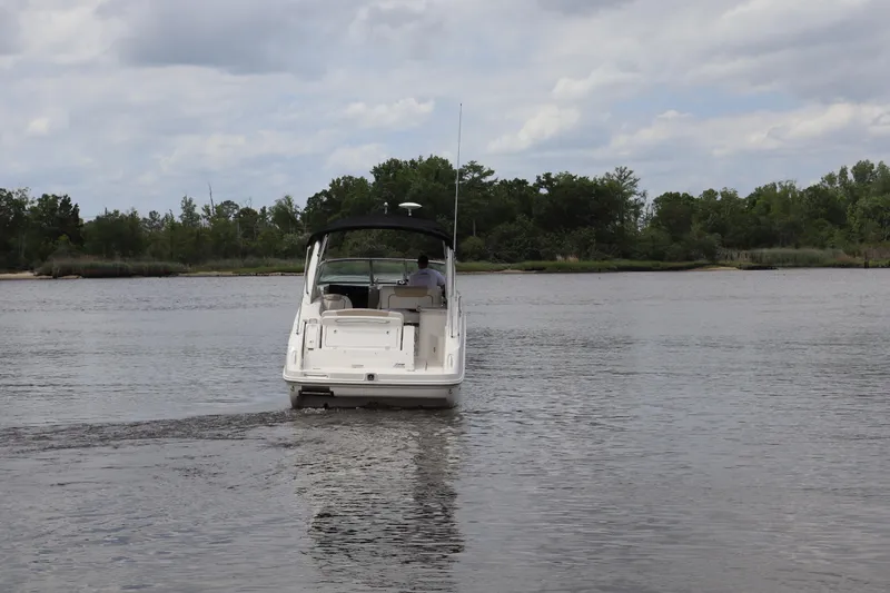 Slide: The Image of 2011 Sea Ray Sundancer 280 cruising on a calm river under a cloudy sky. - 66