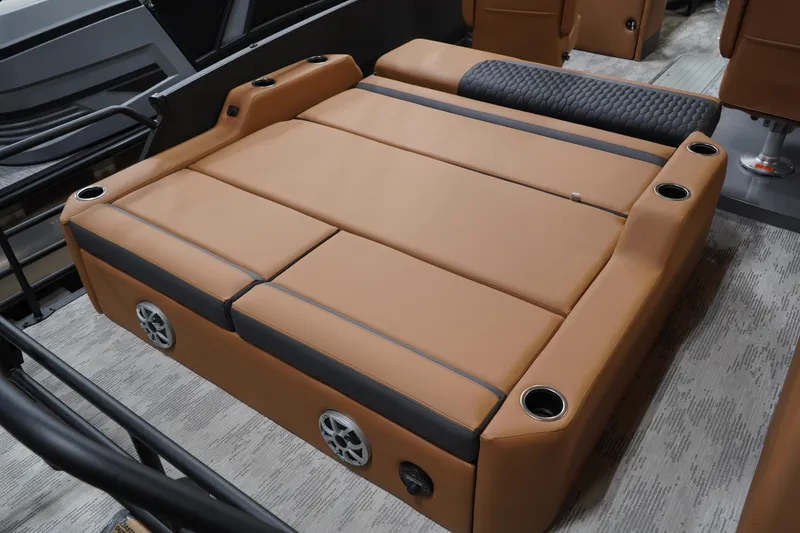 Slide: The Image of Luxurious seating area in the 2026 Sylvan L3 ULZ boat, featuring cup holders and speakers. - 13