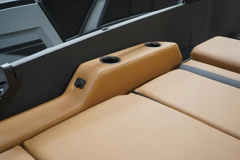 Slide: The Image of 2026 Sylvan L3 ULZ boat interior with tan seating and cup holders. - 16