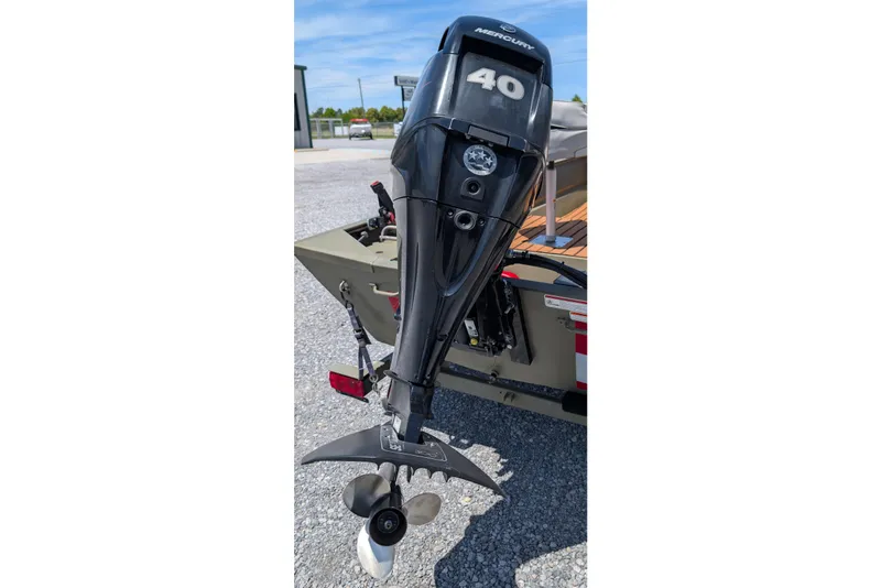 Slide: The Image of 2014 Bass Tracker boat with Mercury 40 outboard motor on gravel surface. - 3