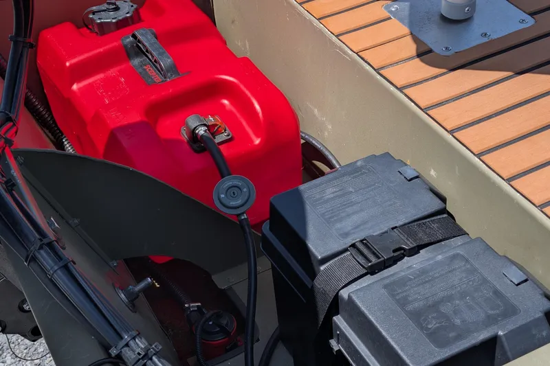 Slide: The Image of 2014 Bass Tracker boat with red fuel tank and battery compartment. - 7