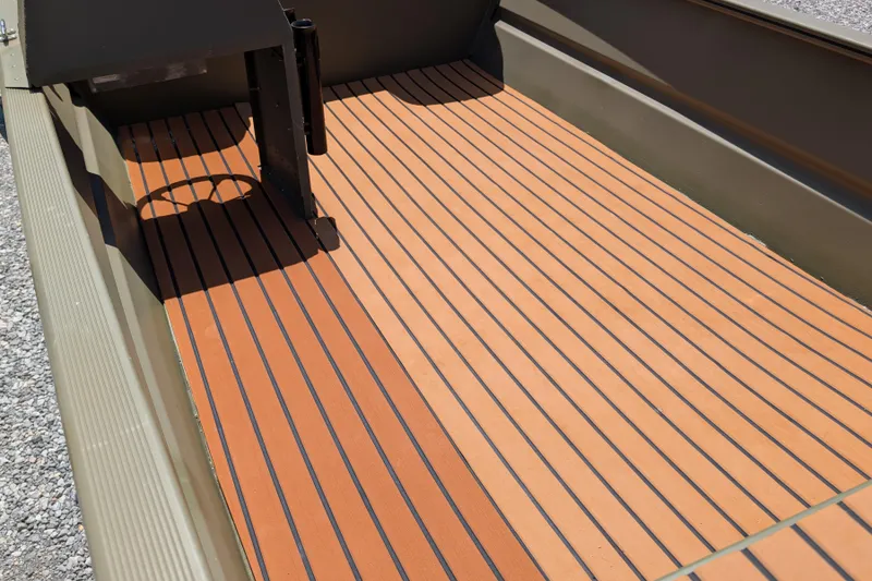 Slide: The Image of 2014 Bass Tracker boat interior with striped wooden flooring, showcasing sleek design. - 9