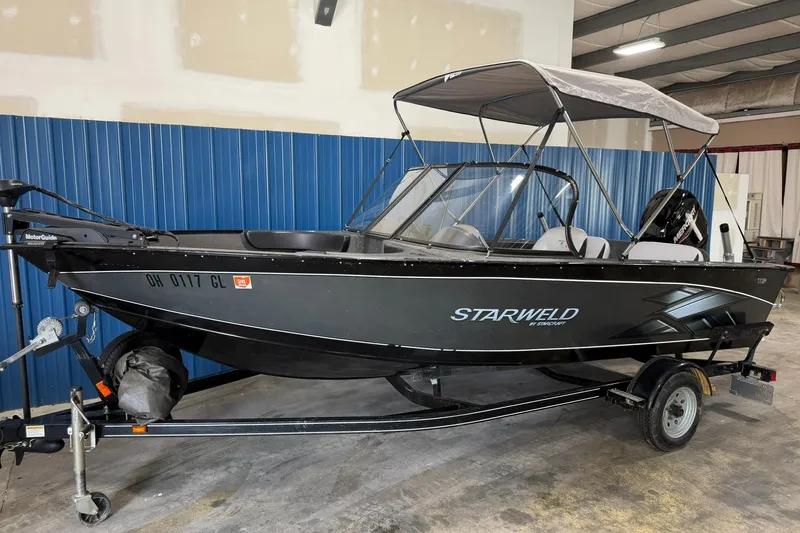 The Image of 2015 Starweld 1600 DC Ski boat on trailer in indoor storage. - 0