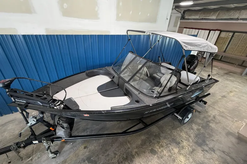 Slide: The Image of 2015 Starweld 1600 DC Ski boat with canopy in indoor storage. - 2