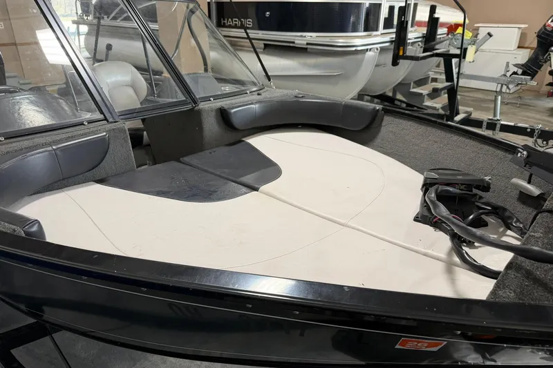 Slide: The Image of 2015 Starweld 1600 DC Ski boat interior with seating and dashboard, in a showroom setting. - 3