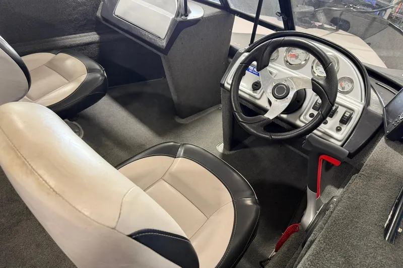 Slide: The Image of Interior of a 2015 Starweld 1600 DC Ski boat, featuring steering wheel and seats. - 5