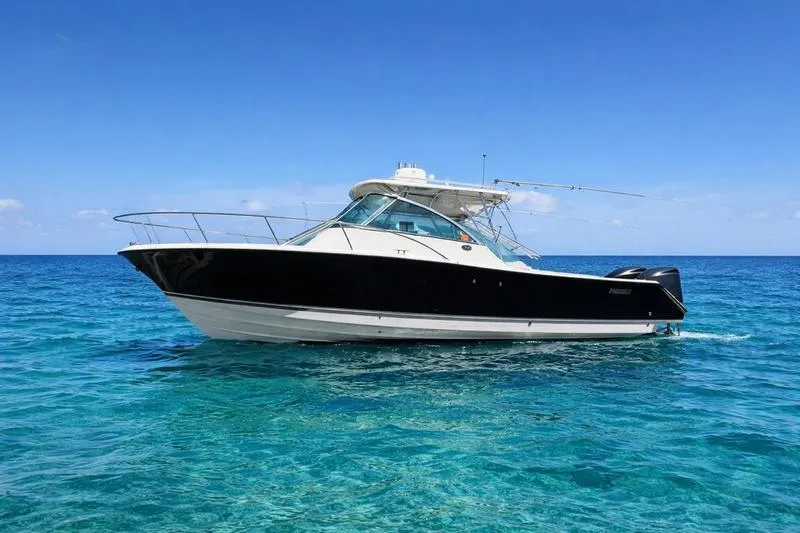 The Image of 2009 Pursuit 345 Drummond Runner LS boat on clear blue ocean water. - 0