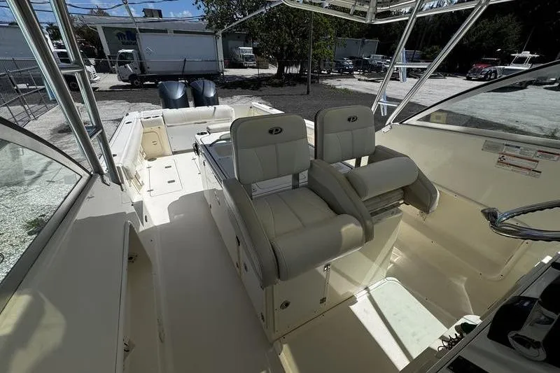 Slide: The Image of 2009 Pursuit 345 Drummond Runner LS boat interior with dual seats and open deck. - 10