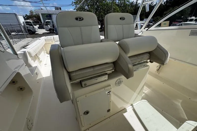 Slide: The Image of 2009 Pursuit 345 Drummond Runner LS boat seats, featuring dual cushioned helm chairs. - 11