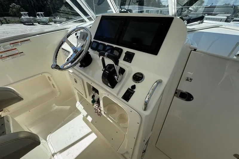 Slide: The Image of 2009 Pursuit 345 Drummond Runner LS boat cockpit with steering wheel and control panel. - 13