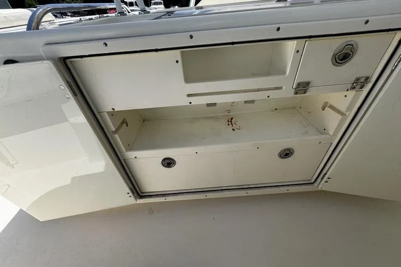 Slide: The Image of Open storage compartment on a 2009 Pursuit 345 Drummond Runner LS boat. - 19