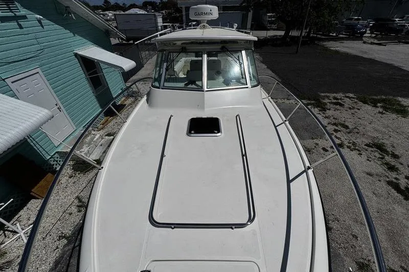 Slide: The Image of 2009 Pursuit 345 Drummond Runner LS boat docked, featuring Garmin equipment. - 22