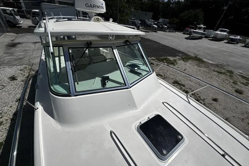 Slide: The Image of 2009 Pursuit 345 Drummond Runner LS boat with Garmin equipment, docked outdoors. - 24