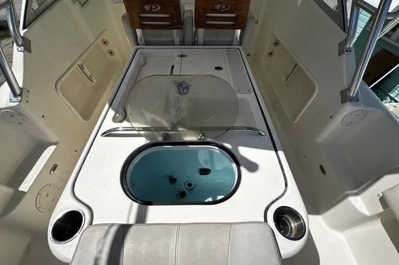 Slide: The Image of 2009 Pursuit 345 Drummond Runner LS boat interior with livewell and seating area. - 25