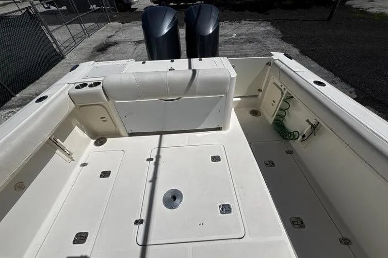Slide: The Image of 2009 Pursuit 345 Drummond Runner LS boat deck with storage compartments and twin engines. - 27