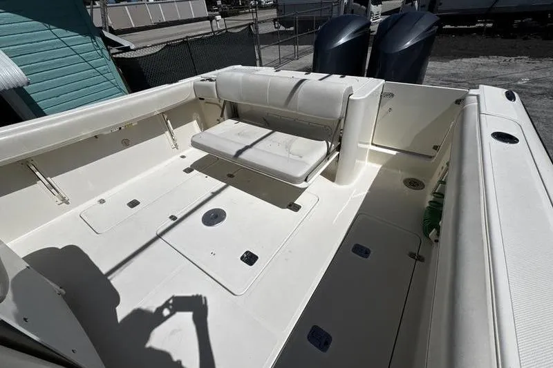Slide: The Image of 2009 Pursuit 345 Drummond Runner LS boat deck with seating and storage compartments. - 28